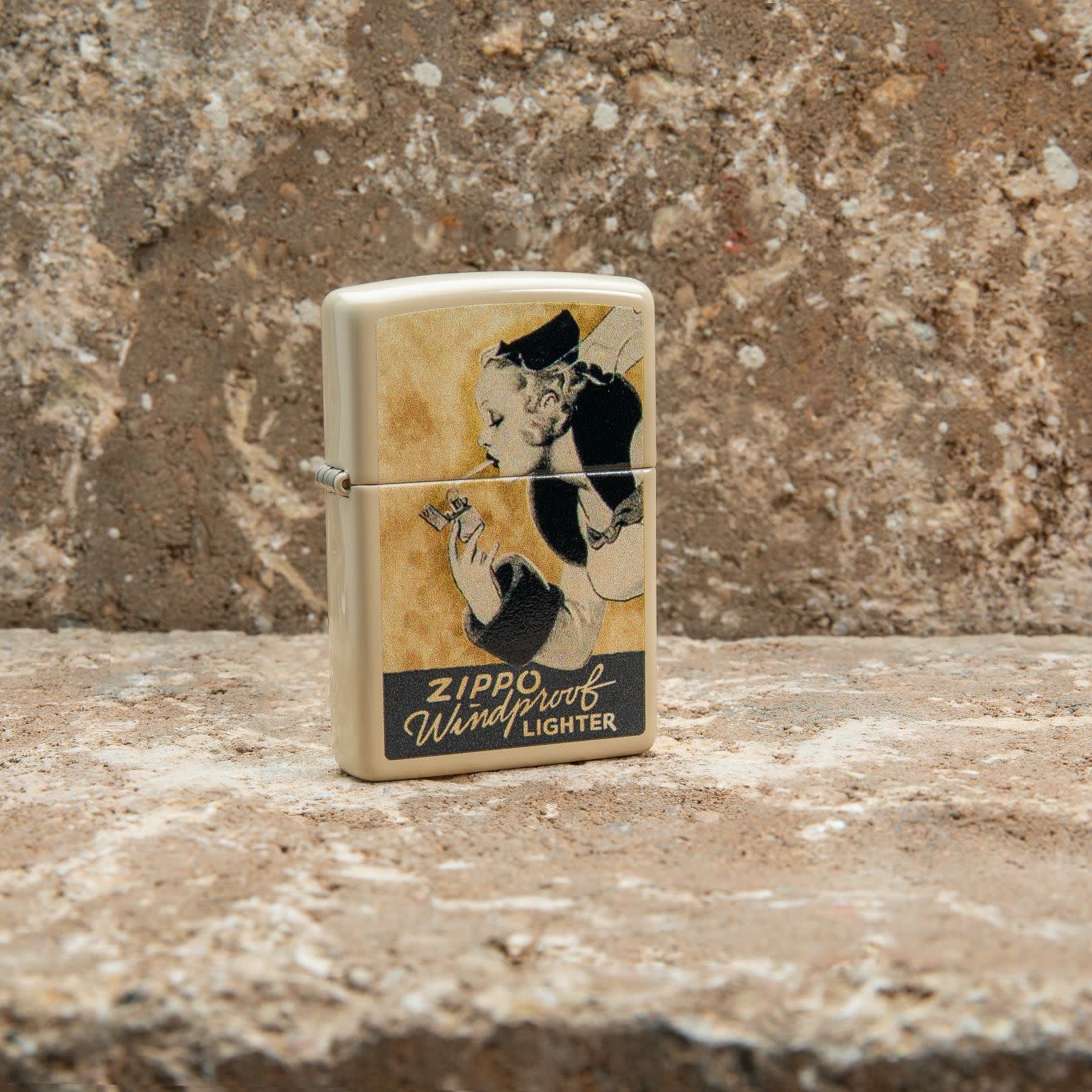 Lifestyle image of Zippo Windy Design Flat Sand Windproof Lighter standing on a countertop.